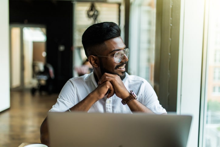 Guilty as Charged: A Cleveland Immigration Lawyer Answers Joel Kotkin on Depopulation 4 Young Indian professional working on a laptop