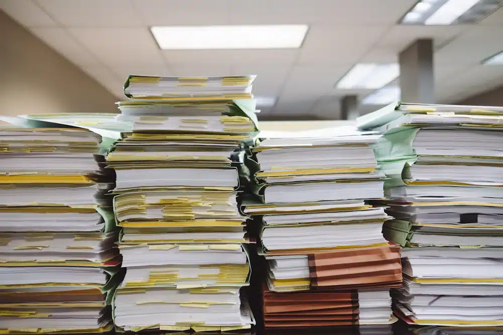 Form I-290B Lawyer: Motions to Reopen or Reconsider 3 Stacks of document folders and supporting records.