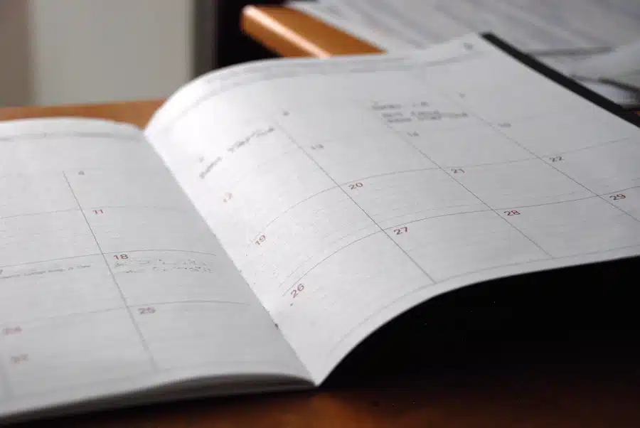 Open paper calendar for recording appointment dates and follow-up